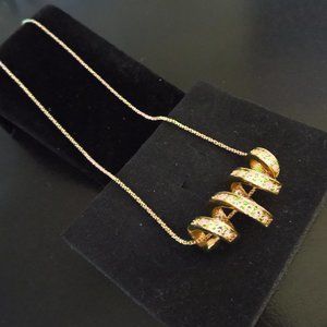 NOLAN MILLER SIDEWAYS GOLDEN SPIRAL RHINESTONES PENDANT NECKLACE EUC 73